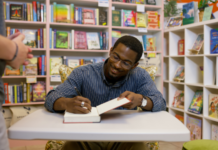 An author signing a book.