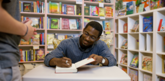 An author signing a book.