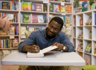 An author signing a book.