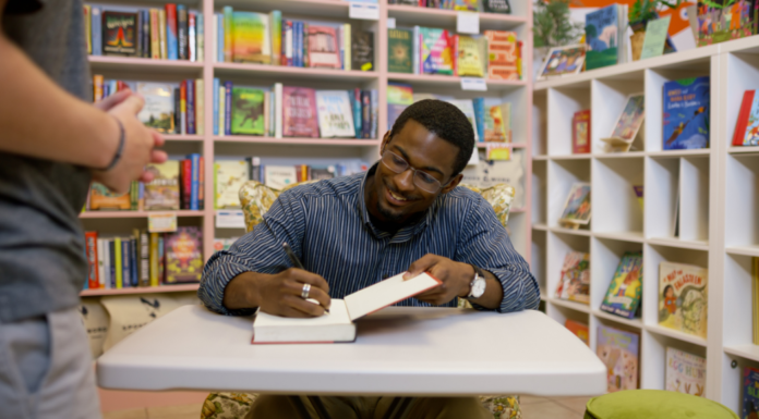 2026 Summer Author Visits An author signing a book.