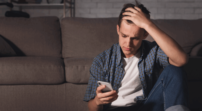 A teen boy on the phone.