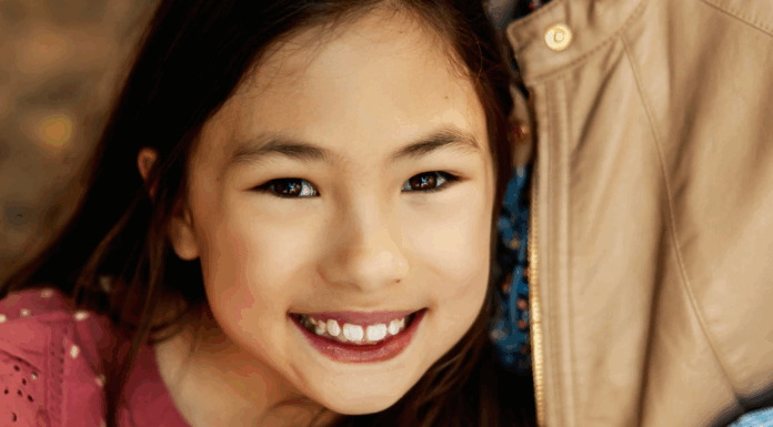 A girl smiling.