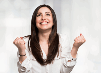 Change Is Scary A woman clenching her fists in happiness.
