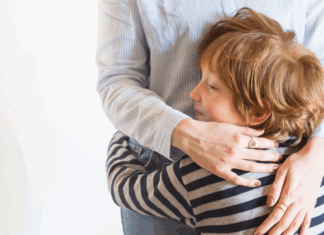 A boy hugging his mom.