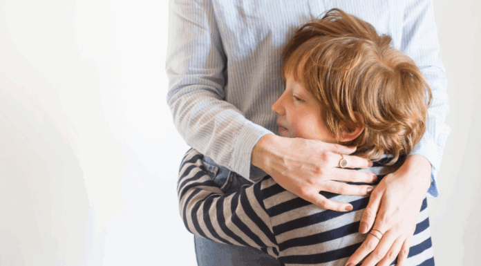 A boy hugging his mom.