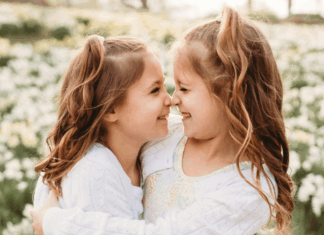 Twin girls embracing.