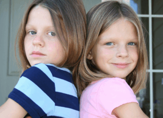 Sisters that have their backs to each other.
