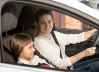A woman driving her tween in the car.