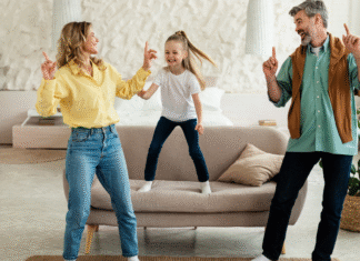 A family dancing in the living room.