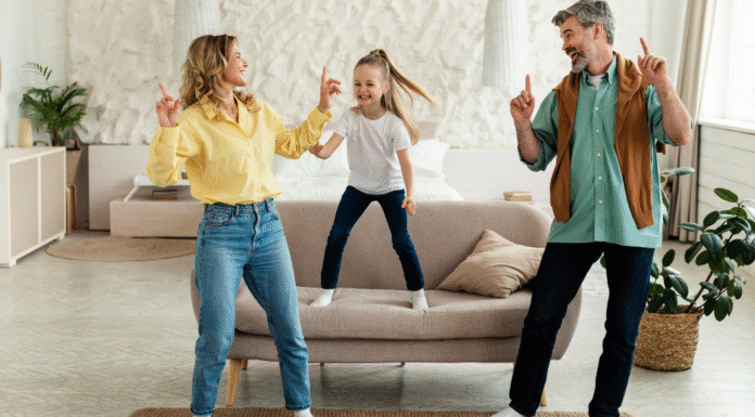 A family dancing in the living room.