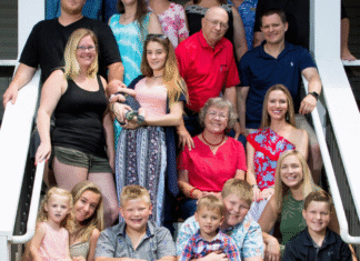 A family sitting on a set of stairs.