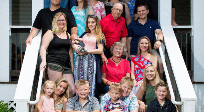 A family sitting on a set of stairs.