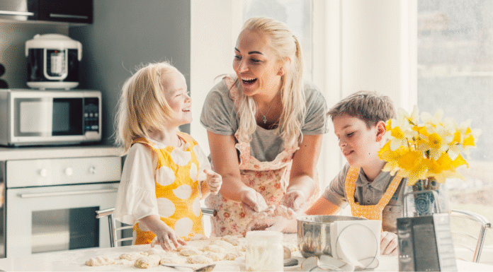 A mom baking and laughing with her kids.