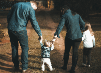 Finding Light in a Heavy World A family walking holding hands.