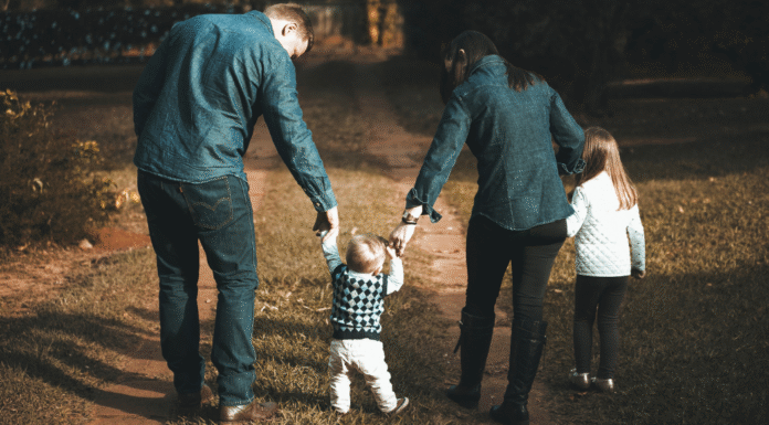 A family walking holding hands.