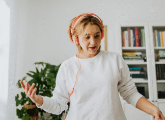 The Life of a Basic Mom A woman listening to music with headphones.
