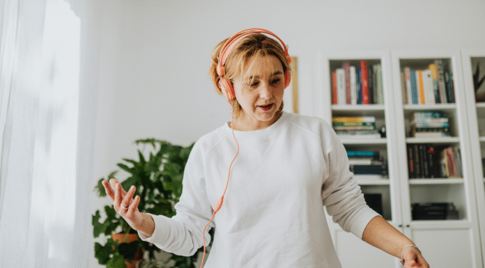 A woman listening to music with headphones.