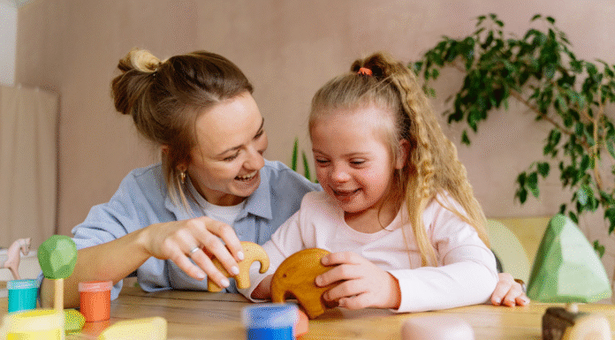 A mom role modeling through play with her daughter.