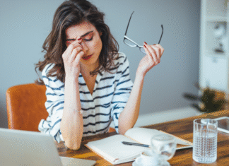 A stressed woman holding her head.