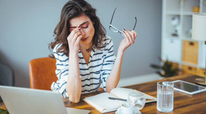 A stressed woman holding her head.
