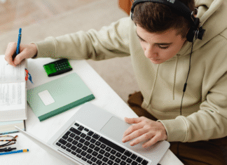 A kid studying and using AI on a computer.