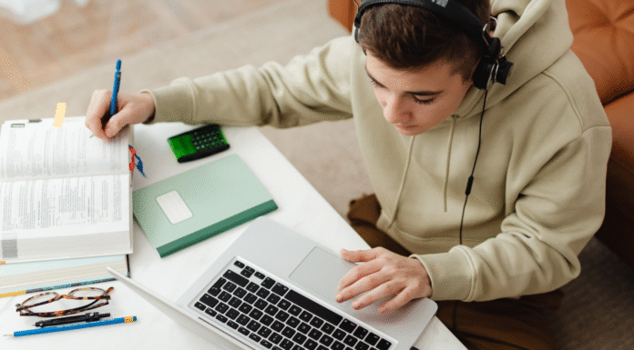 A kid studying and using AI on a computer.