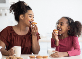 A mom eating snack with her daughter.