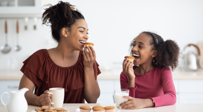 A mom eating snack with her daughter.