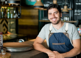A local business man standing at a counter.