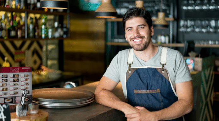 Announcing Our Small Business Giveaway: Win a $2,000 Custom Advertising Campaign for 2026 A local business man standing at a counter.