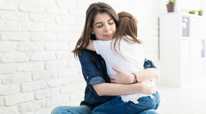 A woman hugging her daughter.