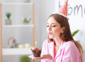 A woman blowing out birthday candles.