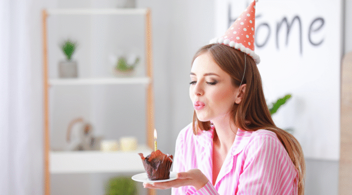 A woman blowing out birthday candles.