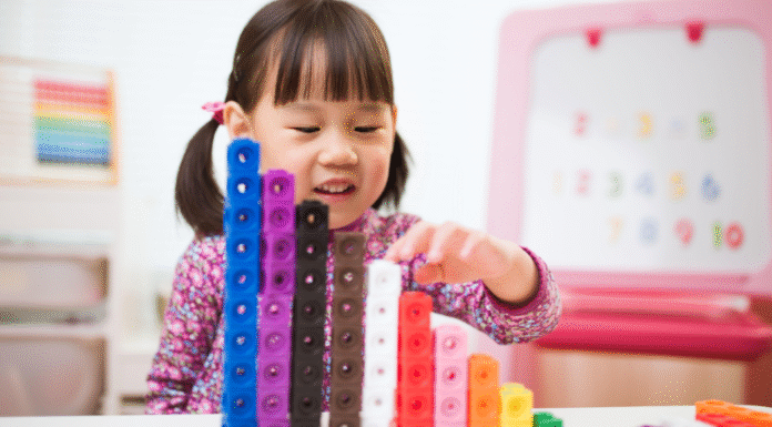 A girl playing with math cubes.