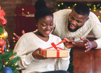 A husband giving his wife a gift on Christmas.