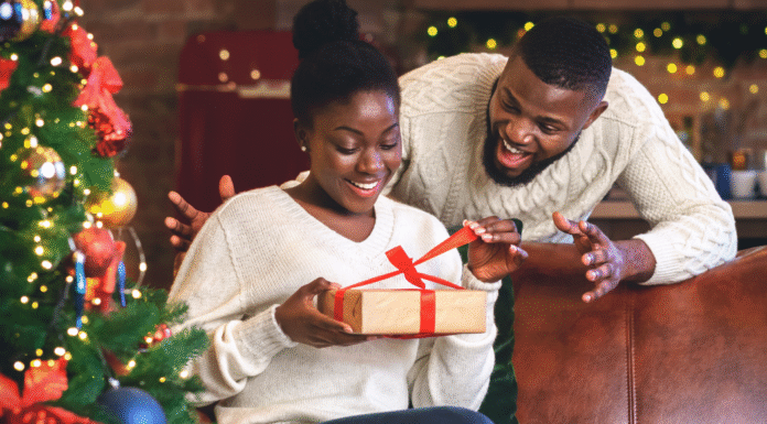A husband giving his wife a gift on Christmas.