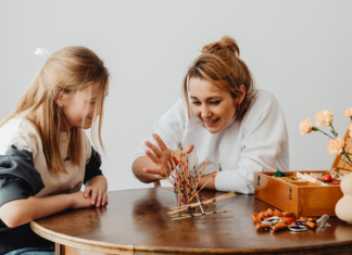 A mom playing a game with her daughter.