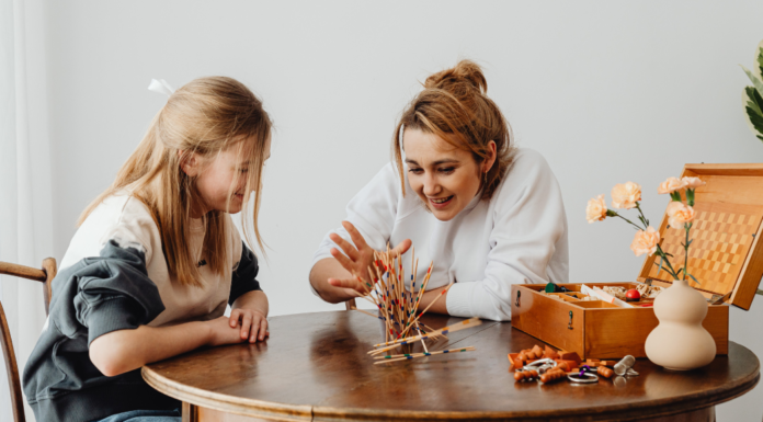A mom playing a game with her daughter.