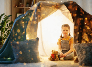 A Mom’s Guide to Surviving Winter Break Without Losing Your Sanity A girl sitting in a fort.