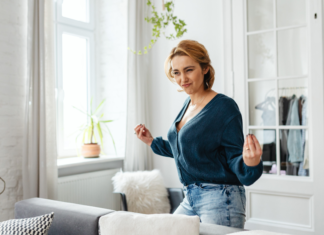 A woman standing in her living room.