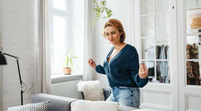 A woman standing in her living room.