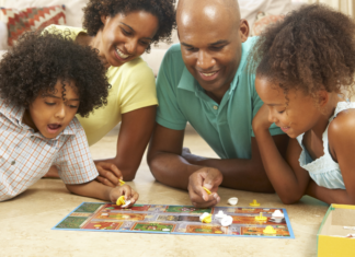 A family play a board game.