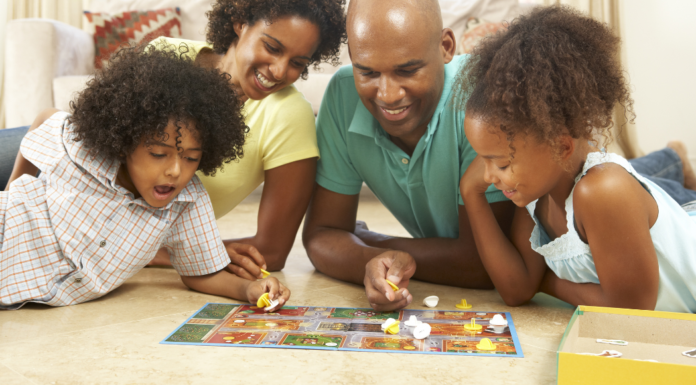 A family play a board game.