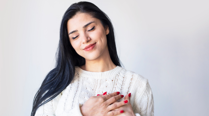 Will I Be My Valentine? A woman holding her hands to her heart.