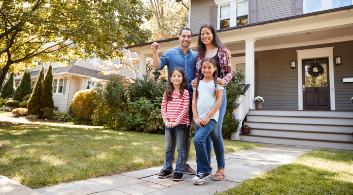 A family standing outside of their home.