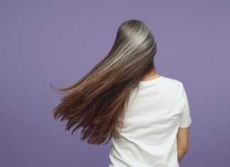 A woman growing out her gray hair.