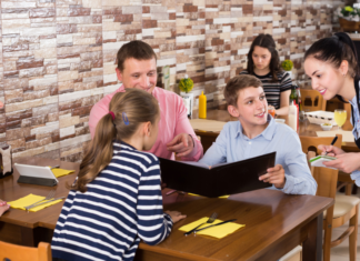 Why I Make My Kids Order for Themselves and Why You Should Too A family ordering food a ta restaurant.