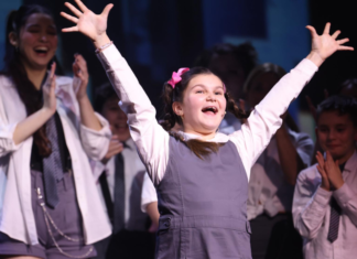 Child celebrating on stage.