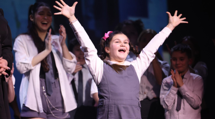 A Seat in the Audience, a Heart on the Stage Child celebrating on stage.