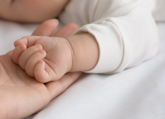 Meet Brittany: Becoming a Mom Later in Life A moms handing holding a baby's hand.